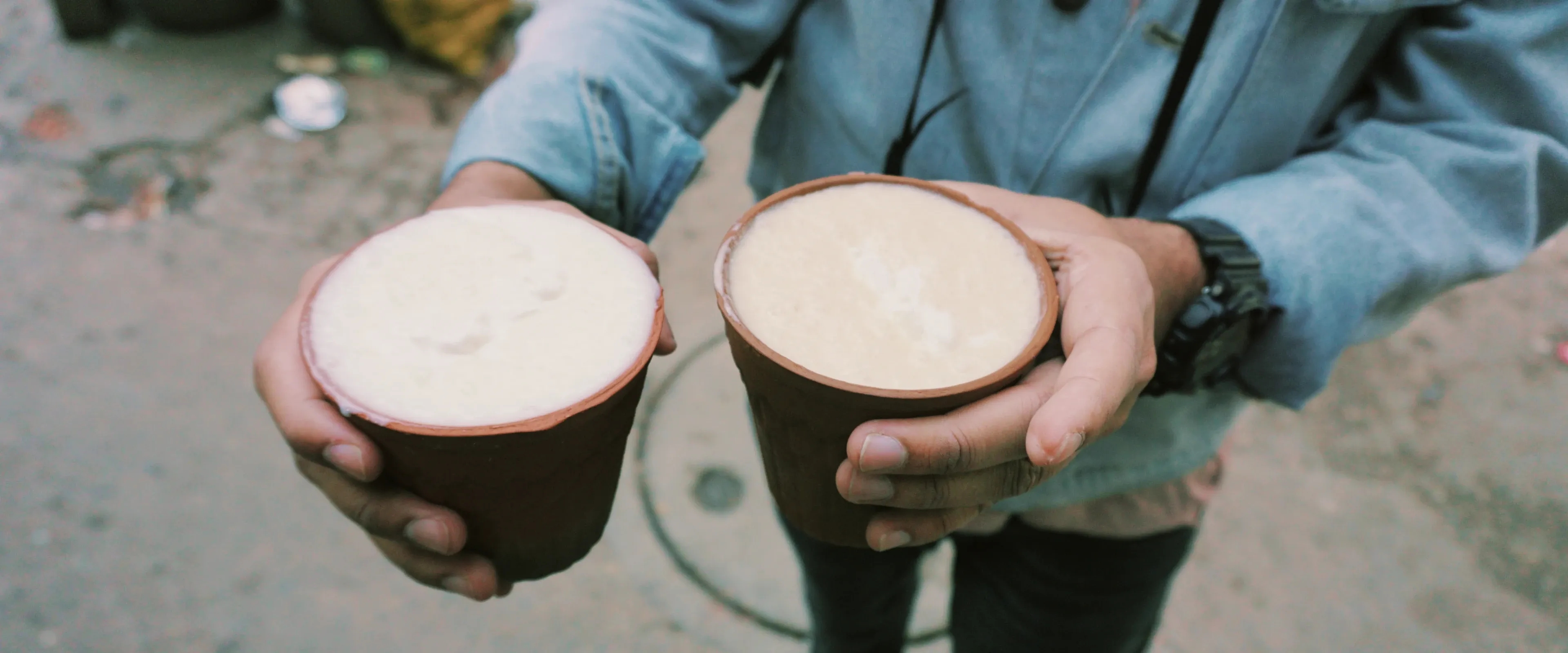 A person holds two cups of bhang lassi